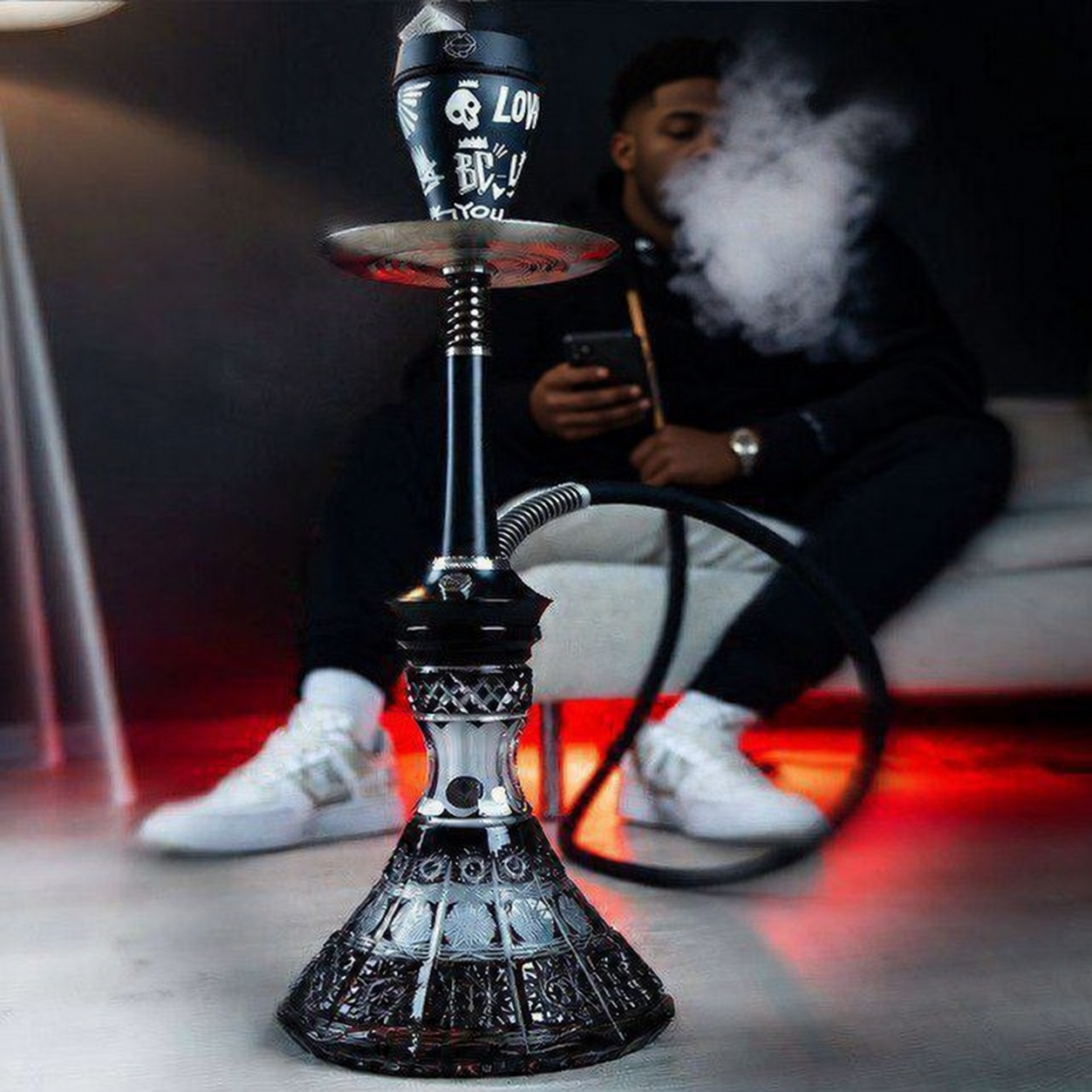 Guest relaxing with a premium hookah pipe